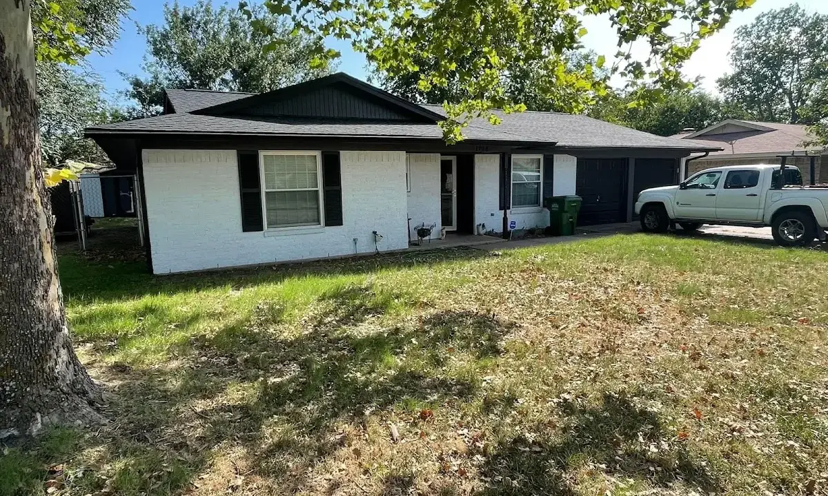 Professional roofing crew working on a residential roof in Willard